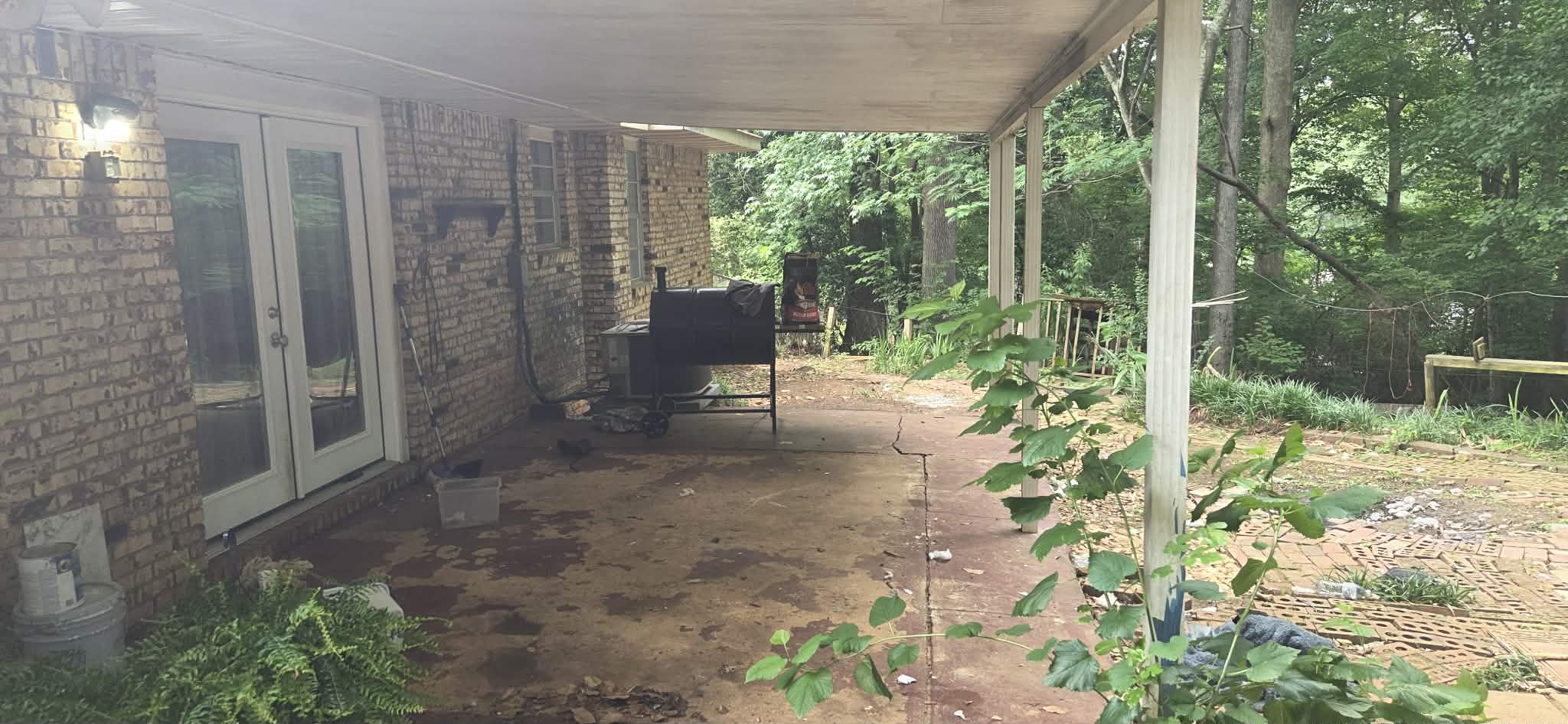 Covered back patio completely cleared after junk removal in Columbus GA