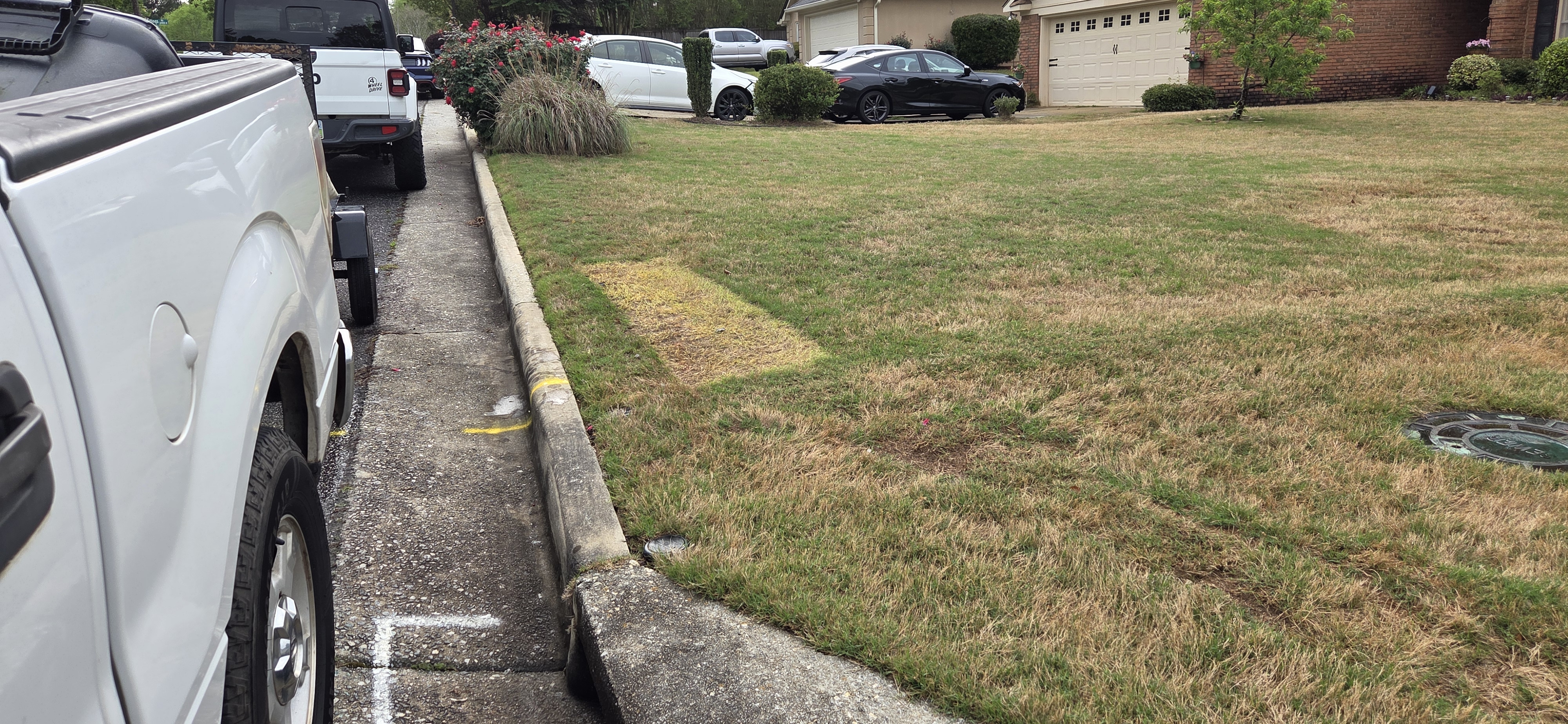 Clean curb after junk pickup in Muscogee County GA — truck on site, all items removed
