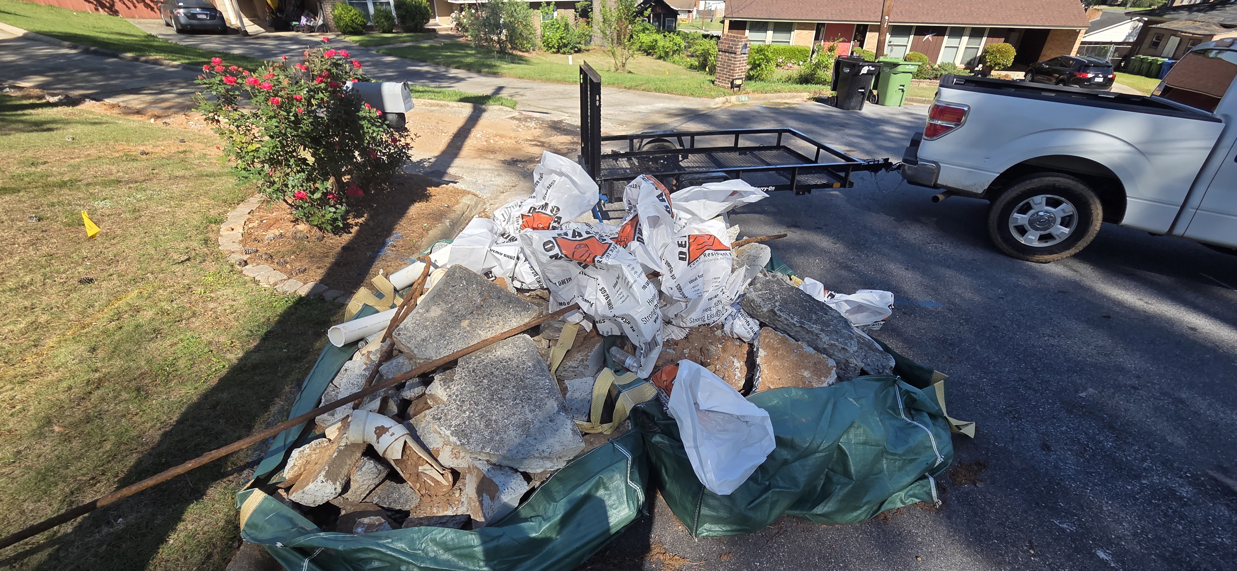 Landscape stone and demo debris pile before haul-off in Columbus GA — contractor cleanup