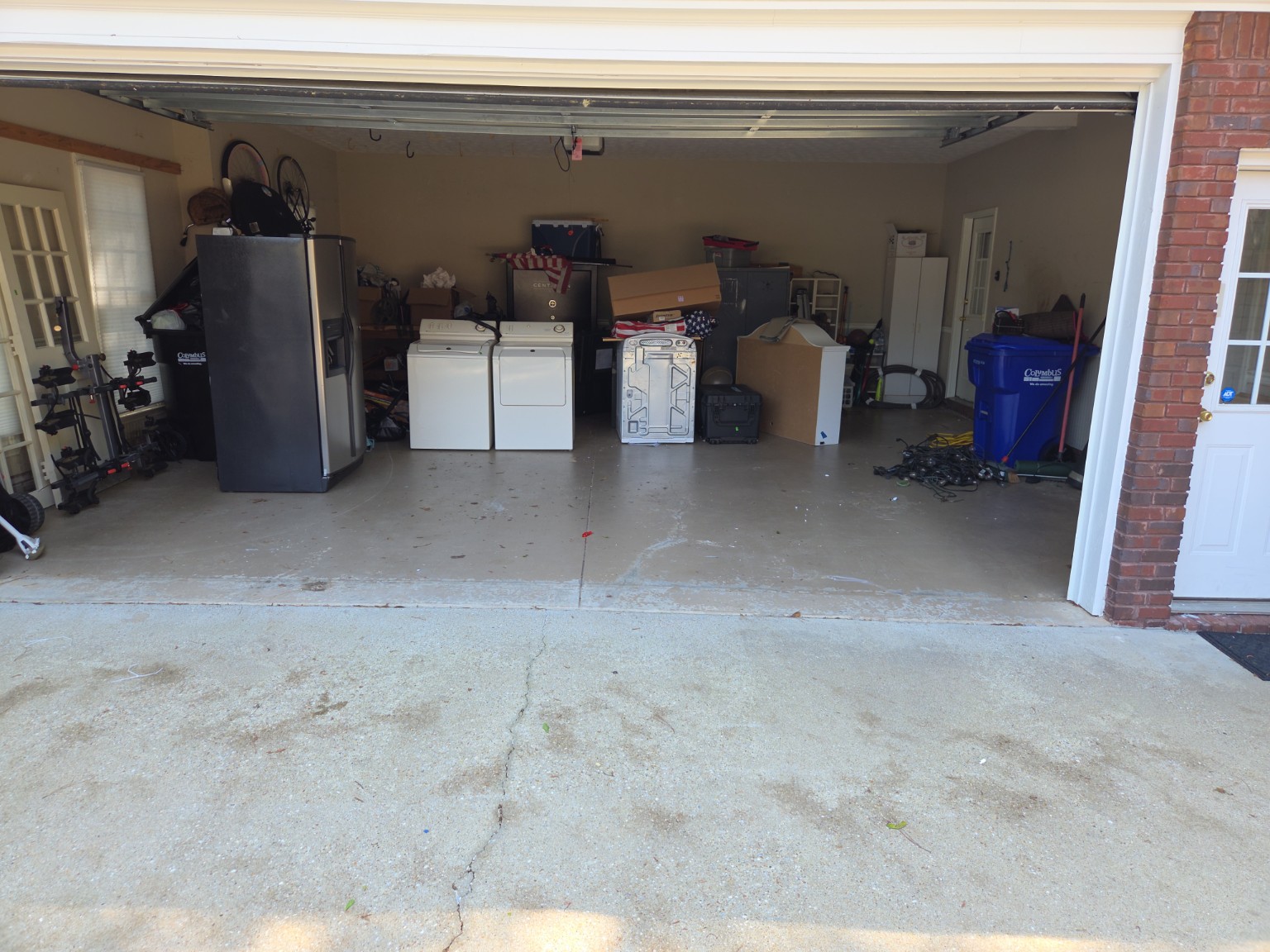 Garage mostly cleared after junk removal in Columbus GA — boxes and clutter removed
