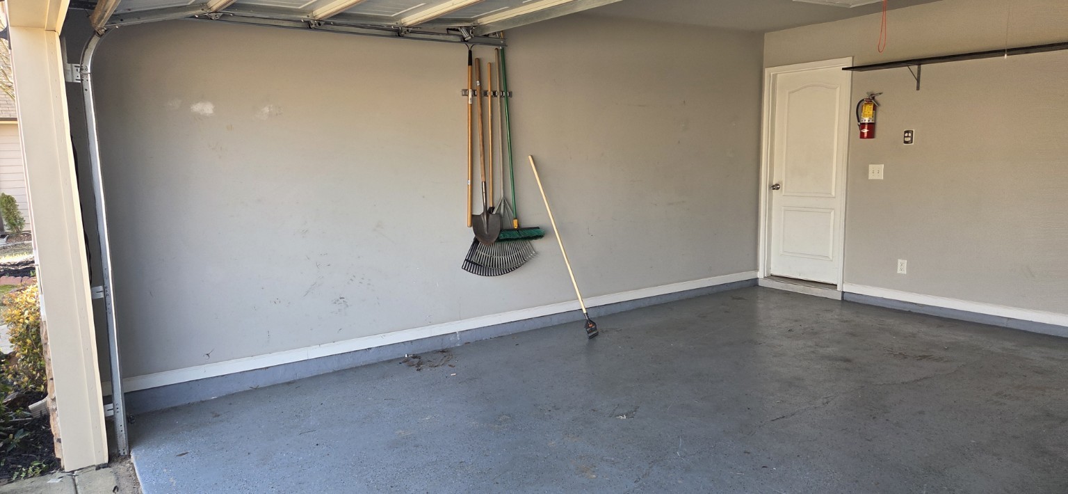 Garage cleanout after — completely empty, floor swept clean near Fort Benning Columbus GA