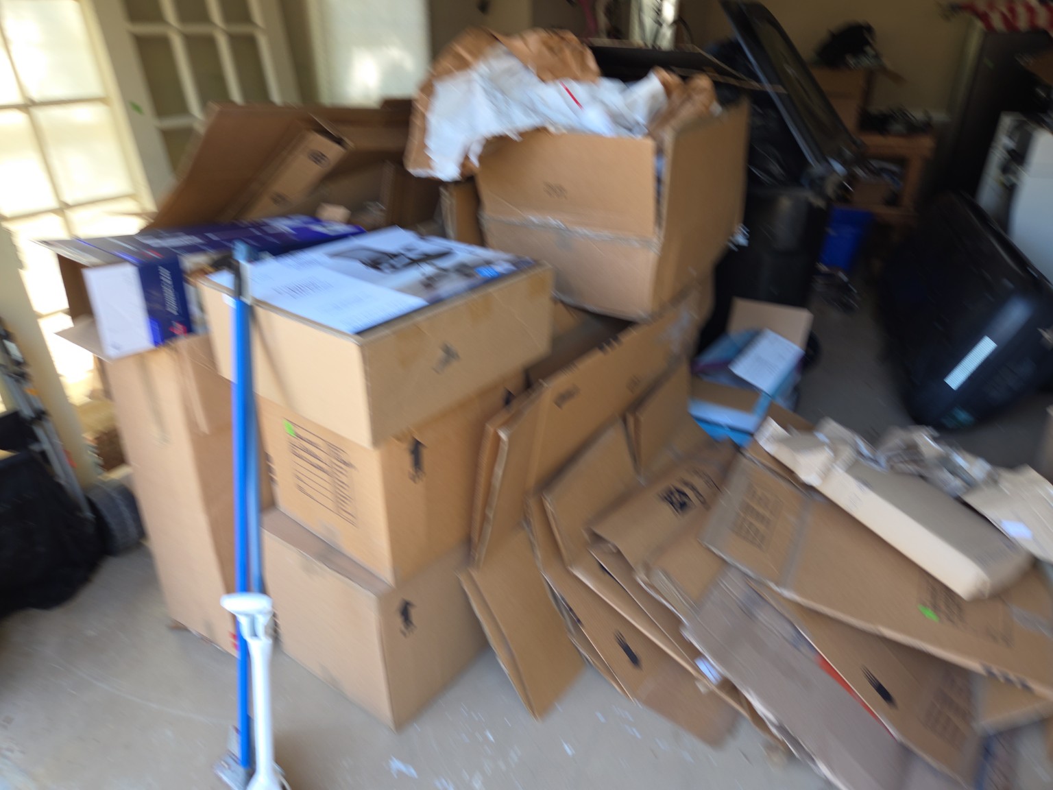 Garage overflowing with boxes and junk before cleanout — Columbus GA garage cleanout service